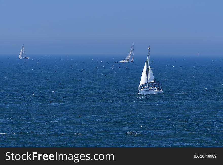 View of the sea with growing white yachts. View of the sea with growing white yachts