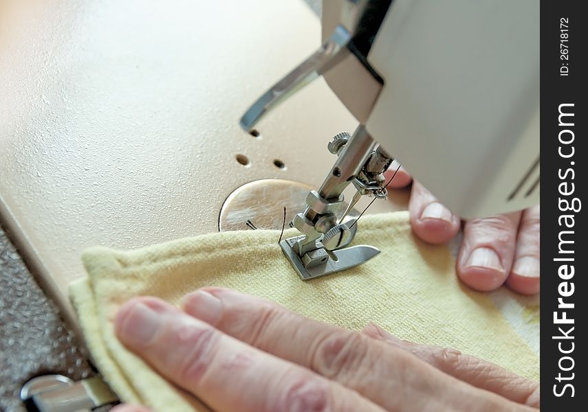 An Elderly Woman Sew On A Typewriter