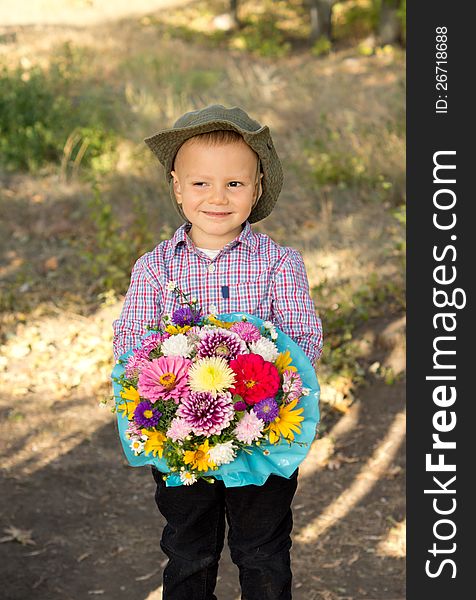 Smiling young boy holding flowers