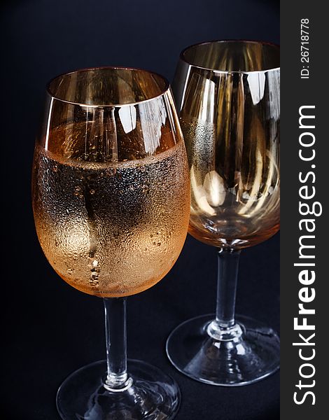 Two glasses of champagne dark background