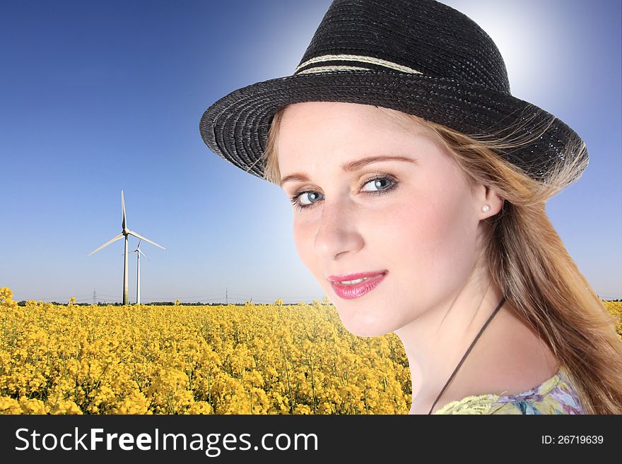 Young girl with windturbuine and field. Young girl with windturbuine and field