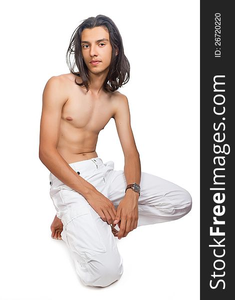 Young swarty guy in white trousers on a white background. Young swarty guy in white trousers on a white background
