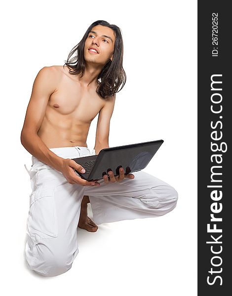 Yuong man posing with laptop in the studio,. Yuong man posing with laptop in the studio,