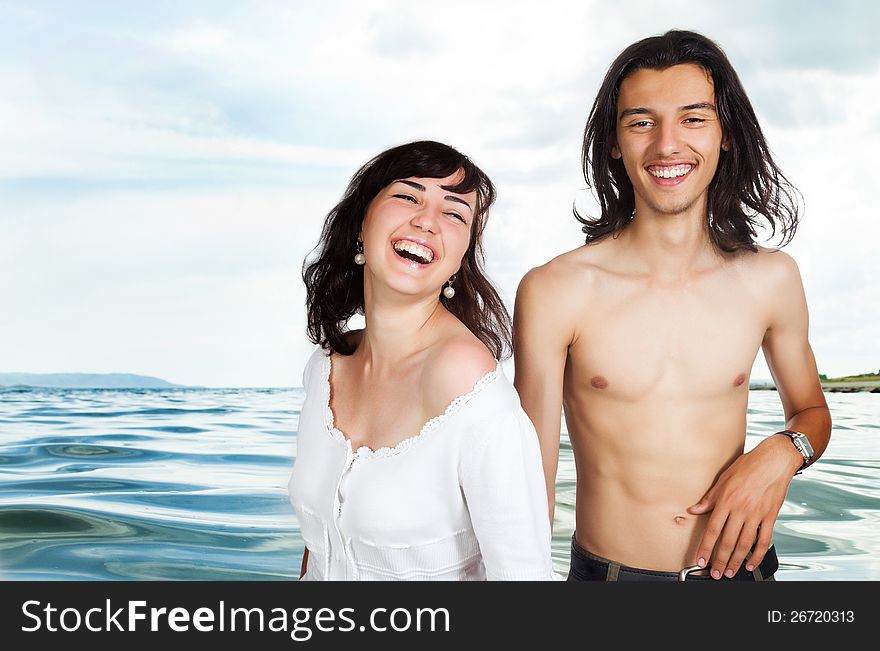Happy young couple on the sea