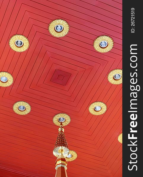 It is red color wooden ceiling with lighting fixtures. It is in pagoda of Thai famous monk. It is red color wooden ceiling with lighting fixtures. It is in pagoda of Thai famous monk