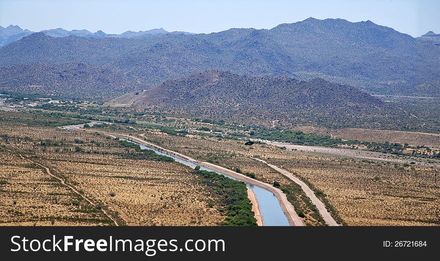 Helicopter flying over an irrigation canal near Mesa, Arizona. Helicopter flying over an irrigation canal near Mesa, Arizona