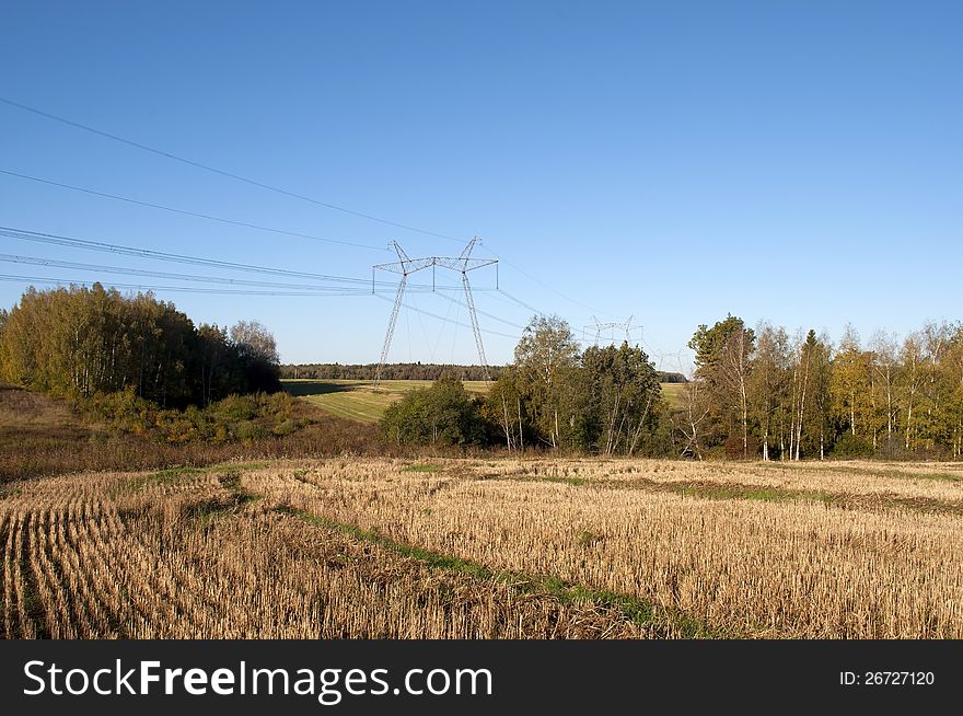 The high-voltage line running through the woods and fields. The high-voltage line running through the woods and fields