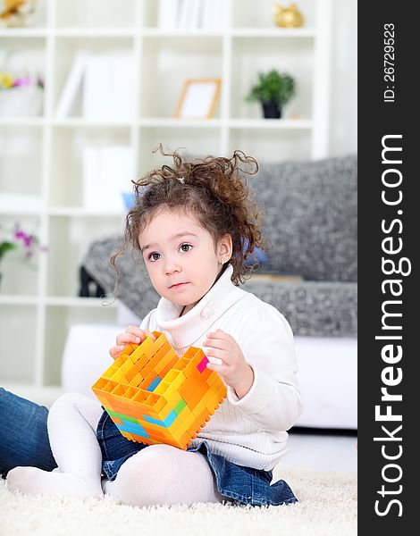 Little girl  playing with blocks at home. Little girl  playing with blocks at home