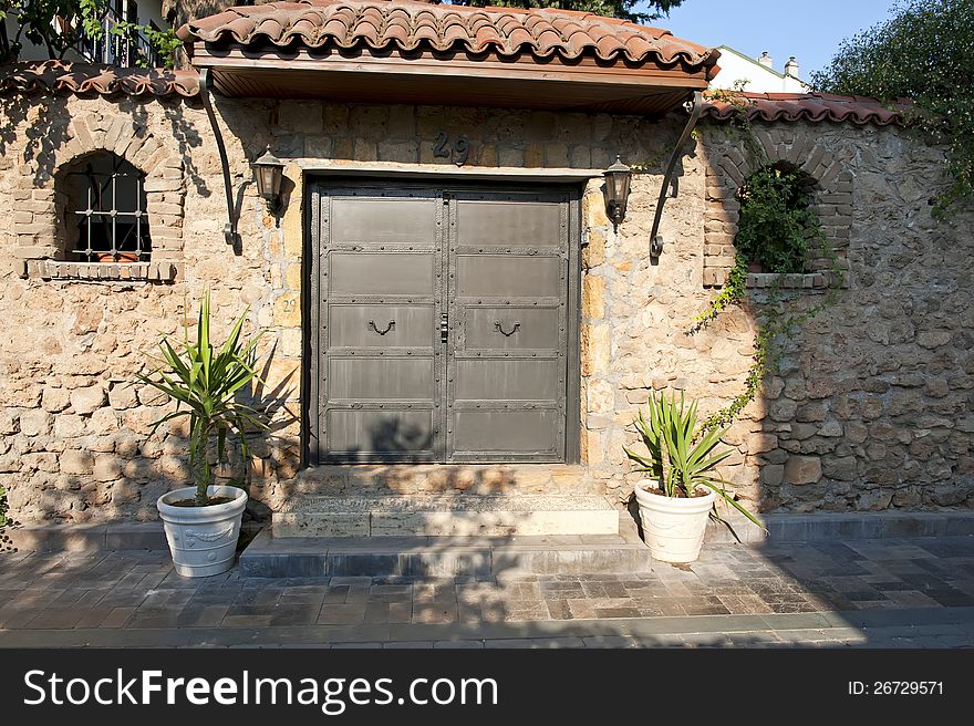 Old stone wall with metallic double door.