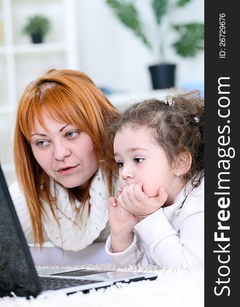 Mother And  Daughter  Using Laptop
