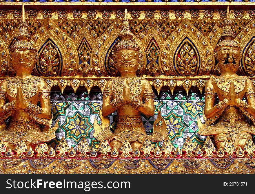 The gold giant sit and clasping hand in locate around Buddhist temple. The gold giant sit and clasping hand in locate around Buddhist temple