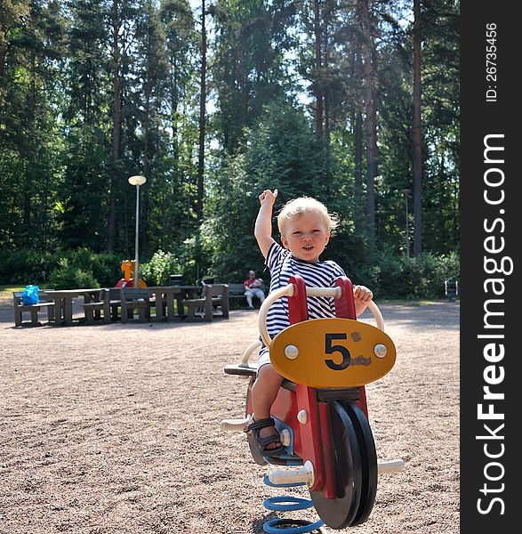 A Cute Young Boy Having Fun On The Playground