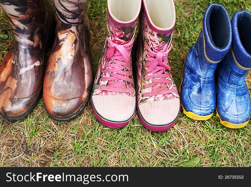 Child and adult wellington boots on the grass