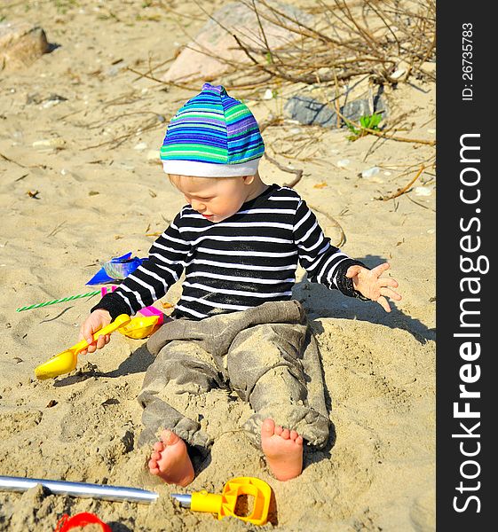 Cute small boy playing on a beach. Cute small boy playing on a beach