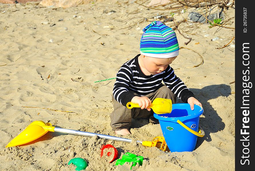 Cute Boy Playing On A Beach