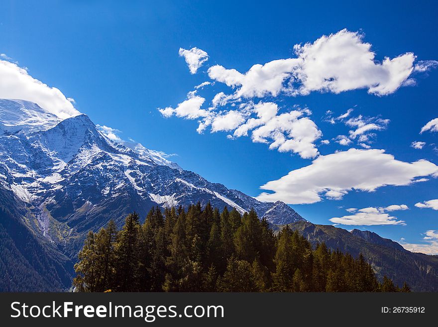 Snow Covered Mountains And Rocky Peaks In The Alps