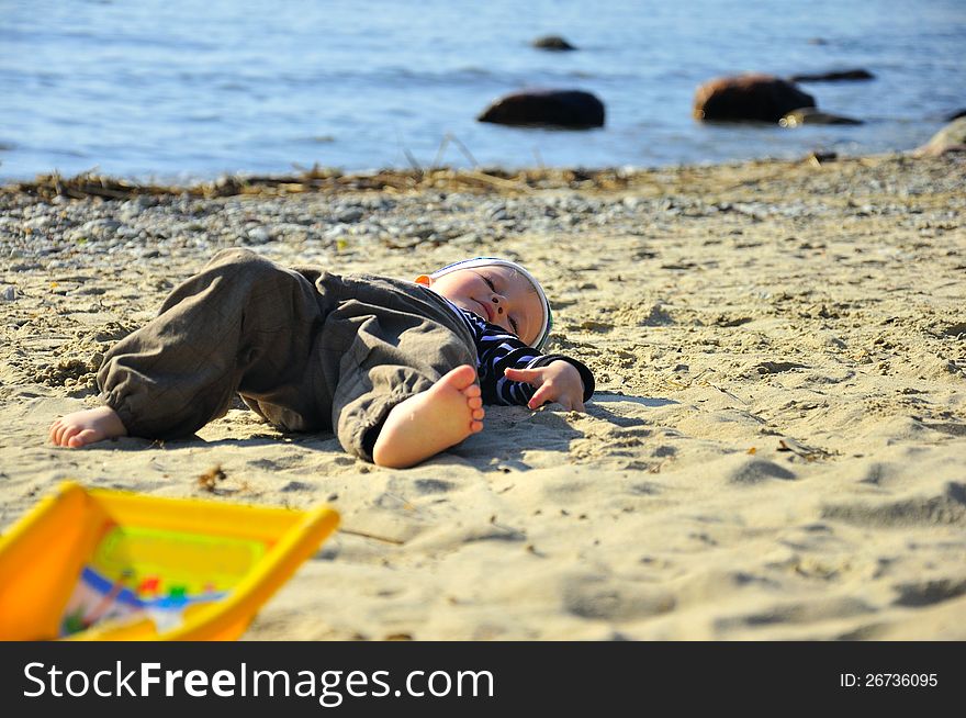 Cute Boy Playing On A Beach