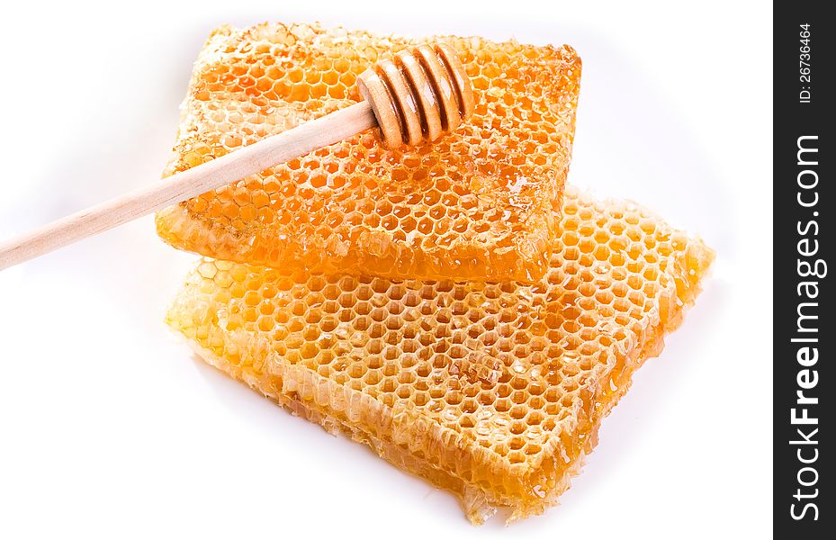 Honeycombs with drizzler on white background