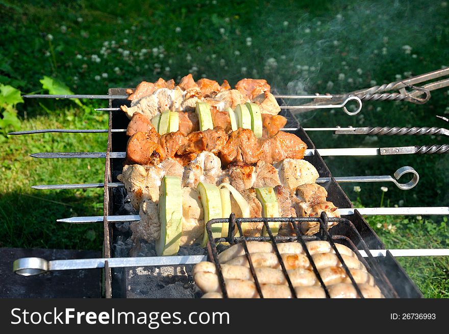 Tasty grill kebab saslyk on a charcoal with onion