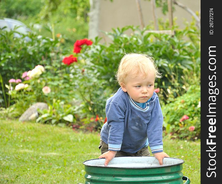 Little baby boy gardener playing.
