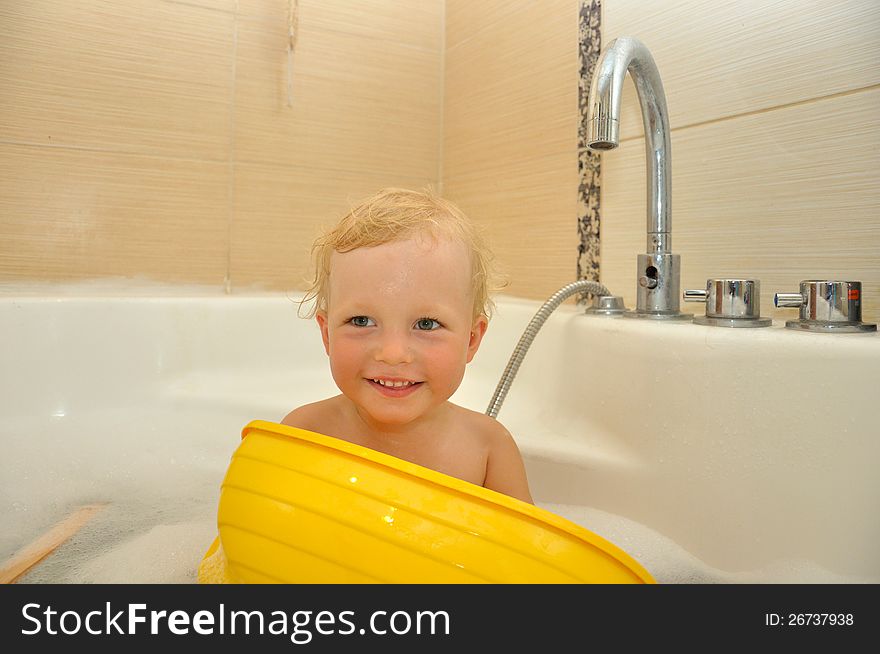 Happy Child Bathes In A Bathroom