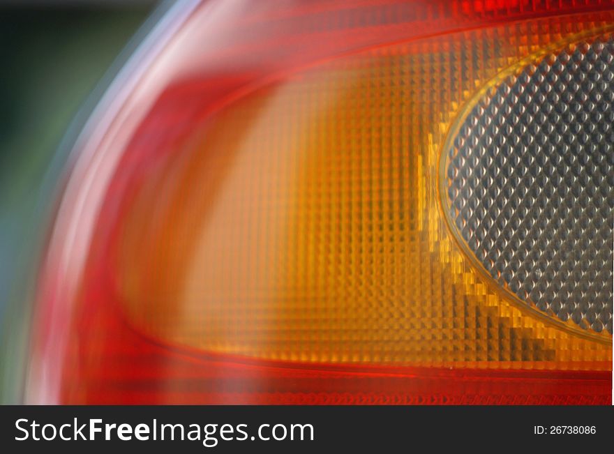 Detail of red and orange rear light of car