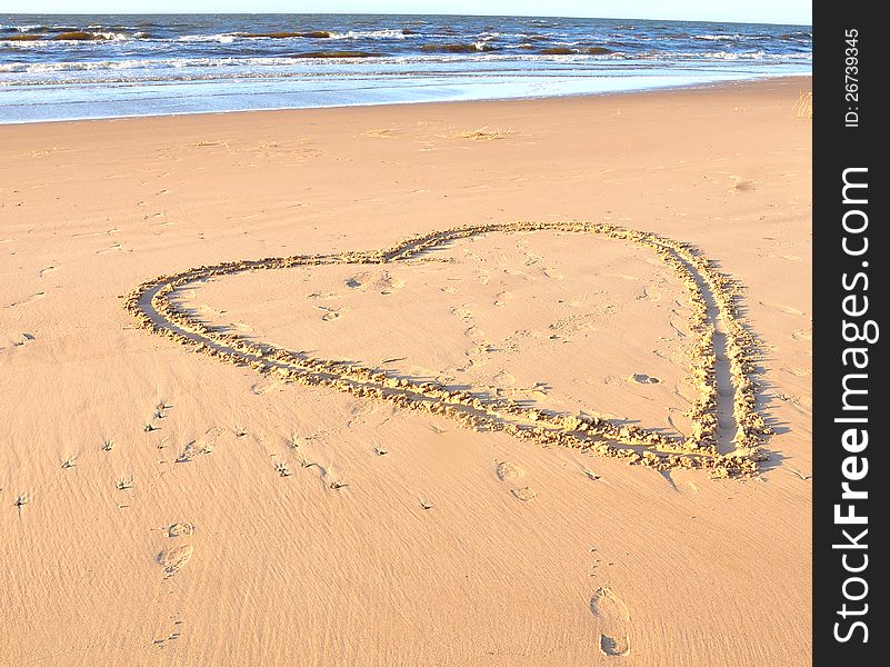 Heart Drawn In A Sand On A Beach And Sea