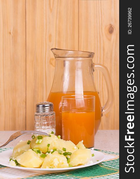 Boiled potatoes, juice and salt shaker