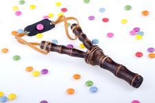 Slingshot And Candies Stock Photos