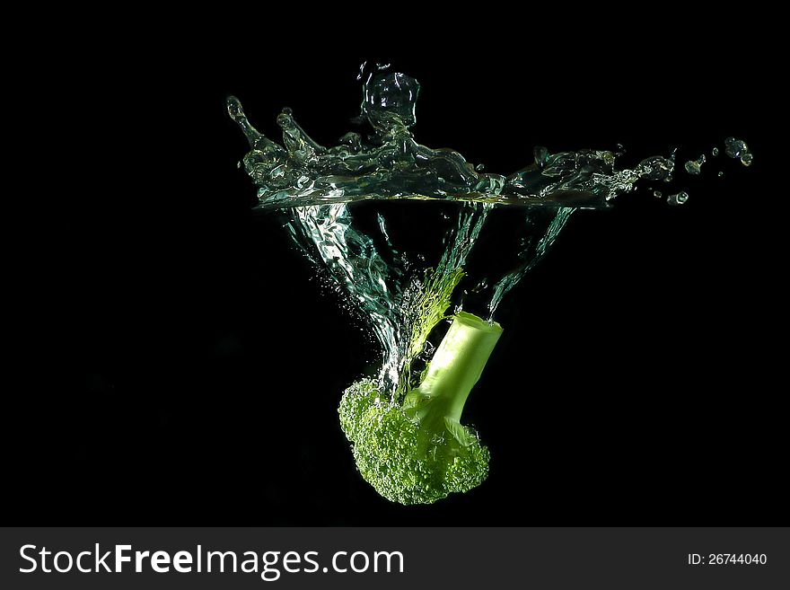 Picture of a vegetable - broccoli dropped under water. Picture of a vegetable - broccoli dropped under water