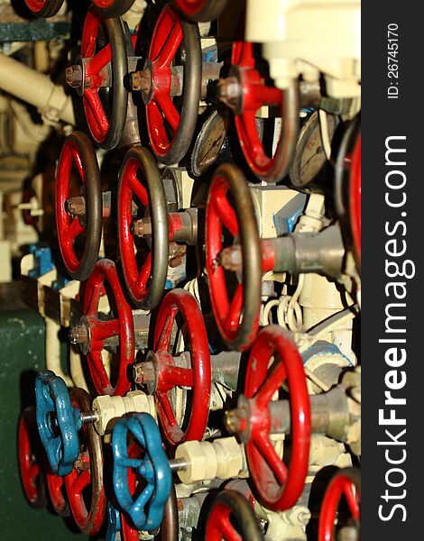 Numerous red wheels are located in the Russian Scorpion submarine docked at the Queen Mary in Long Beach CA USA. Raw Image Available. Numerous red wheels are located in the Russian Scorpion submarine docked at the Queen Mary in Long Beach CA USA. Raw Image Available