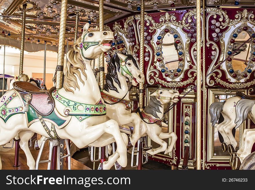 Closeup of a colorful indoor carousel ride.