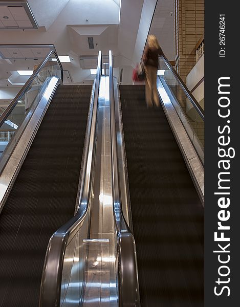 Dual escalators with steps blurred by motion inside a shopping mall. Dual escalators with steps blurred by motion inside a shopping mall.