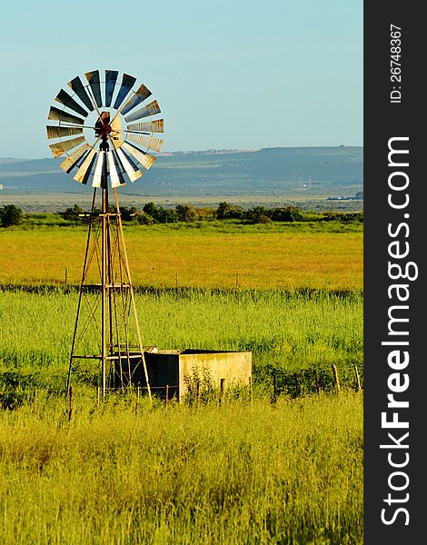 Landscape with windmill water pump on a farm westerncape south africa