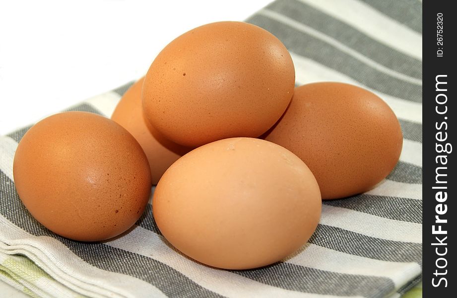 Fresh eggs on dishcloth gray and white