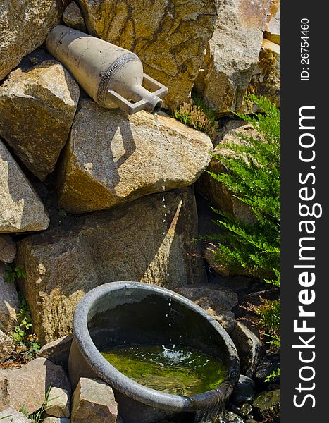 Fine small falls with green stones below