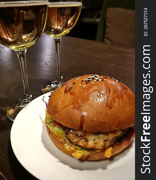 Burger With Meat And Two Glasses Of Cider