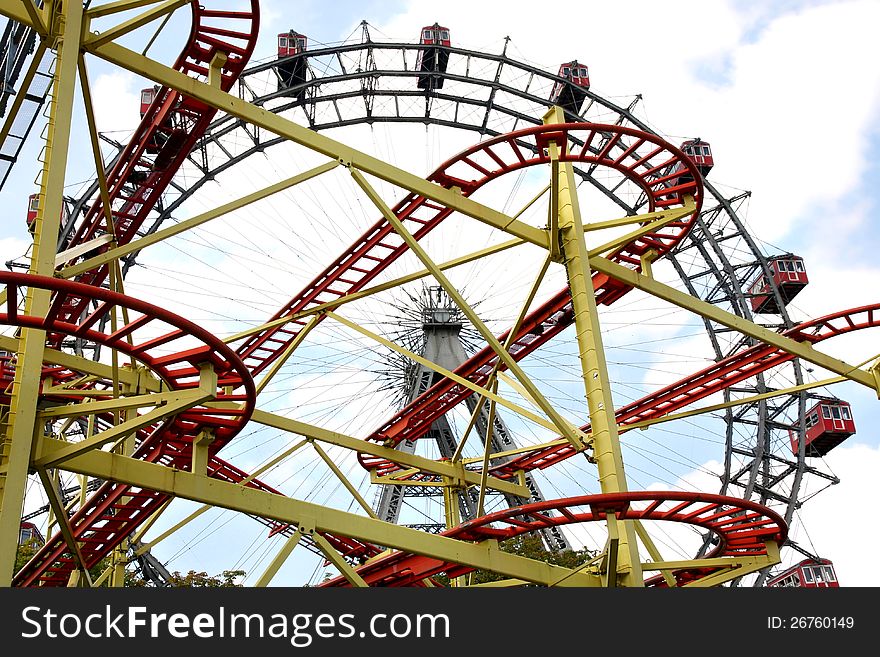 Roller coaster and large ferris wheel in Prater, Vienna, Austria