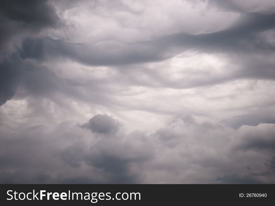 Dense, dark storm clouds with an interesting pattern. Dense, dark storm clouds with an interesting pattern
