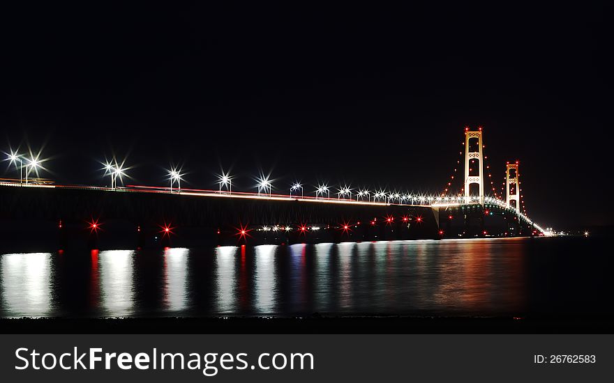 The Mackinac Bridge is located on Interstate 75 in northern Michigan at the Straits of Mackinac. The bridge connects Michigan's upper and lower peninsulas. The Mackinac Bridge is located on Interstate 75 in northern Michigan at the Straits of Mackinac. The bridge connects Michigan's upper and lower peninsulas.