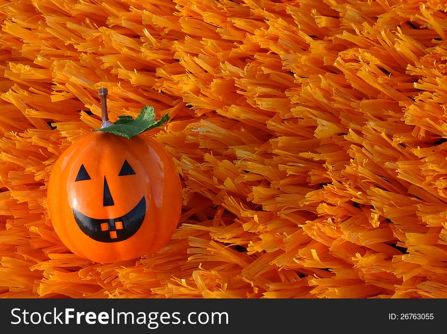 Jack-o-lantern on orange artificial turf. Jack-o-lantern on orange artificial turf