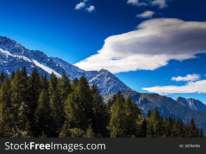 Snow covered mountains and rocky peaks in the French Alps in the Mont Blanc Massif. Snow covered mountains and rocky peaks in the French Alps in the Mont Blanc Massif