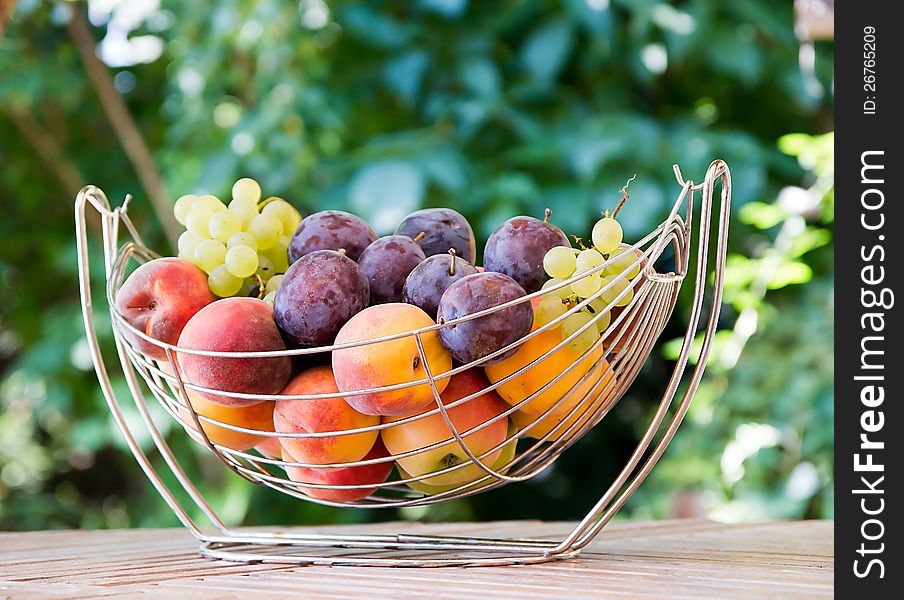 Mix of autumn fruits:grapes,plums,apple,peach