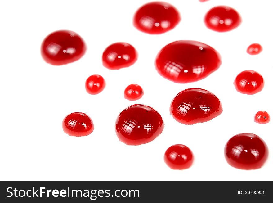 Red plum jam drops on a white background. Red plum jam drops on a white background