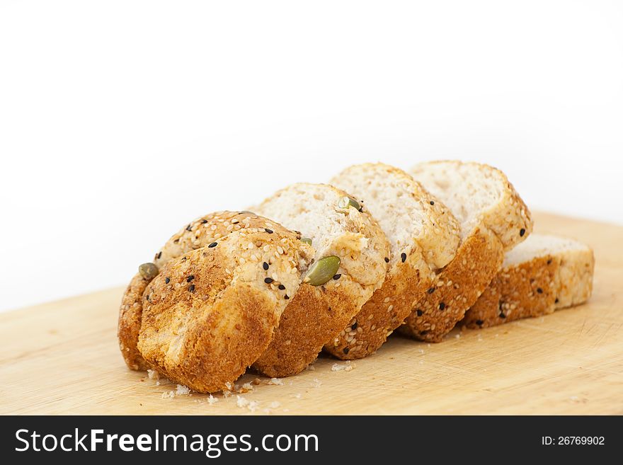 Fresh wholewheat bread with sunflower seeds Sesame and slices on black background. Fresh wholewheat bread with sunflower seeds Sesame and slices on black background