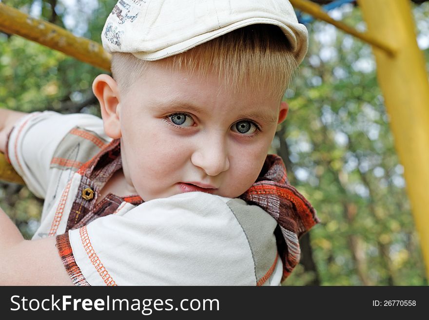 Boy in a cap on a walk in the park