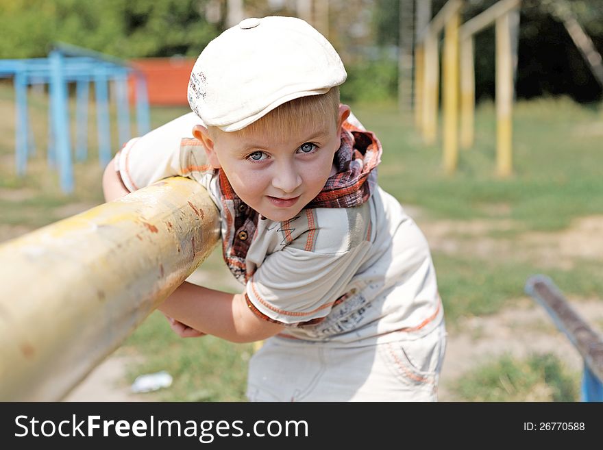 Portrait of a boy wearing a cap in the park