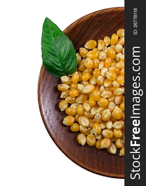 Plate with grain corn and basil leaf