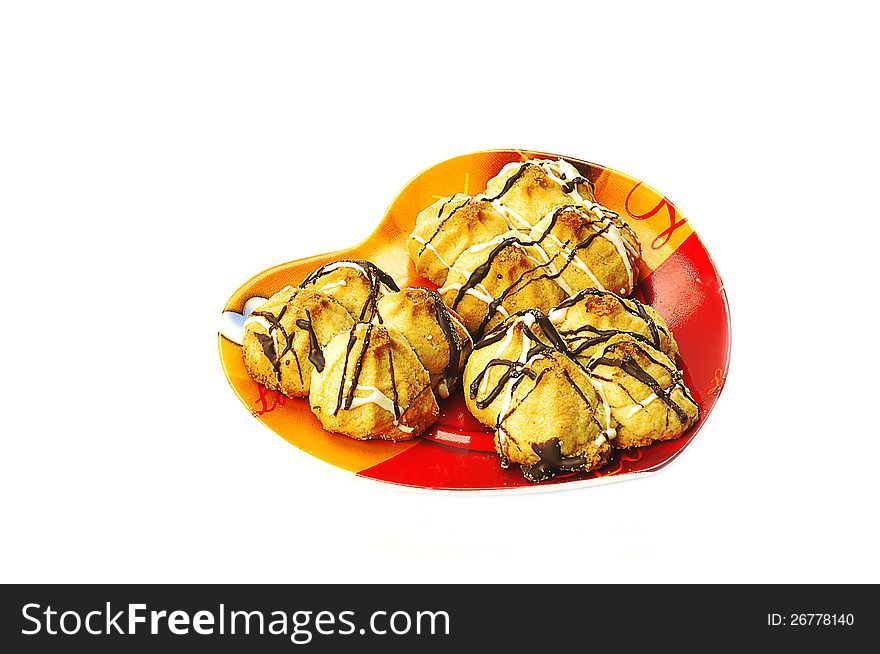 Shortbread cookies on a yellow-red plates in the shape of heart. Shortbread cookies on a yellow-red plates in the shape of heart