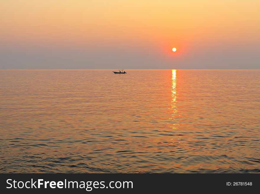 Boat in the sea at sunset.